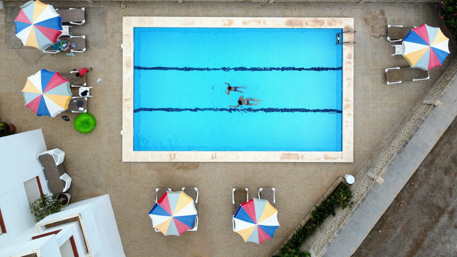 Aerial view of a hotel pool with umbrellas